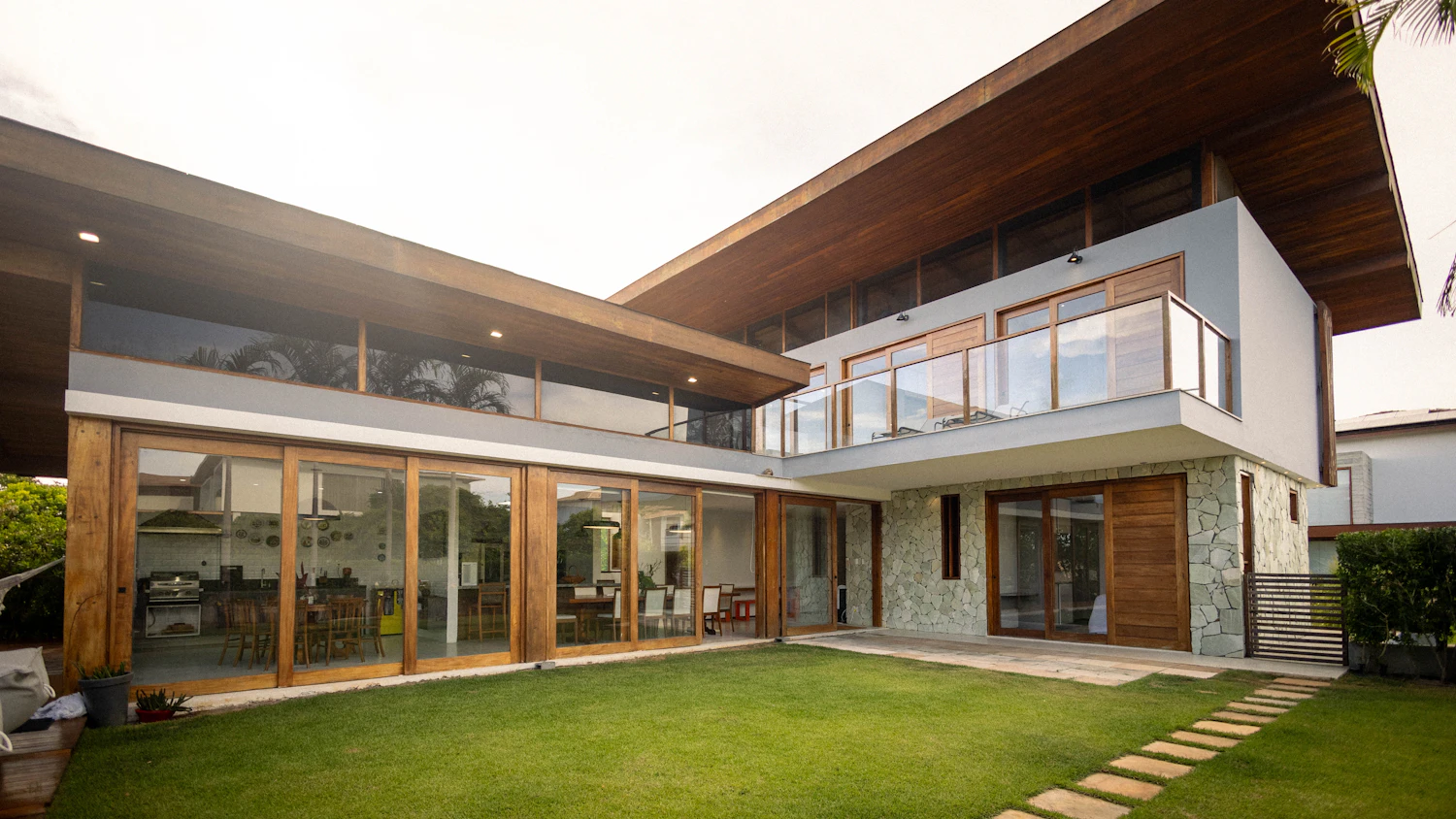 Two-storey house with timber eaves and a lawn