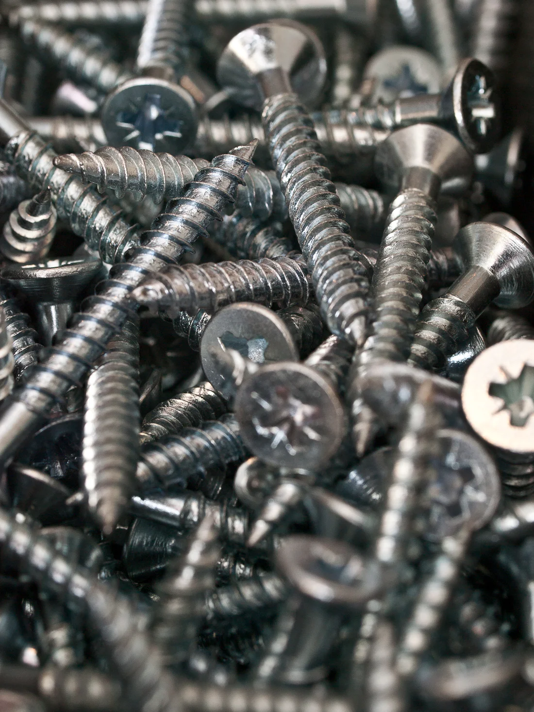 A pile of steel screws, seen close up