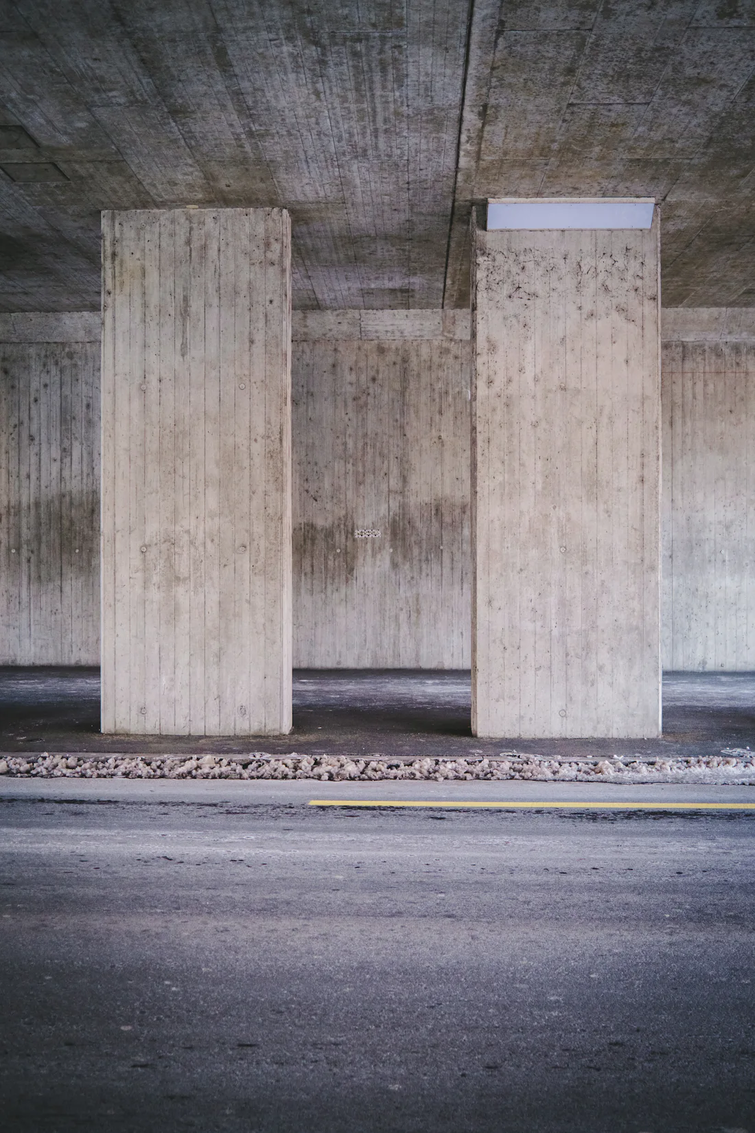 Two square concrete pillars holding up a concrete slab