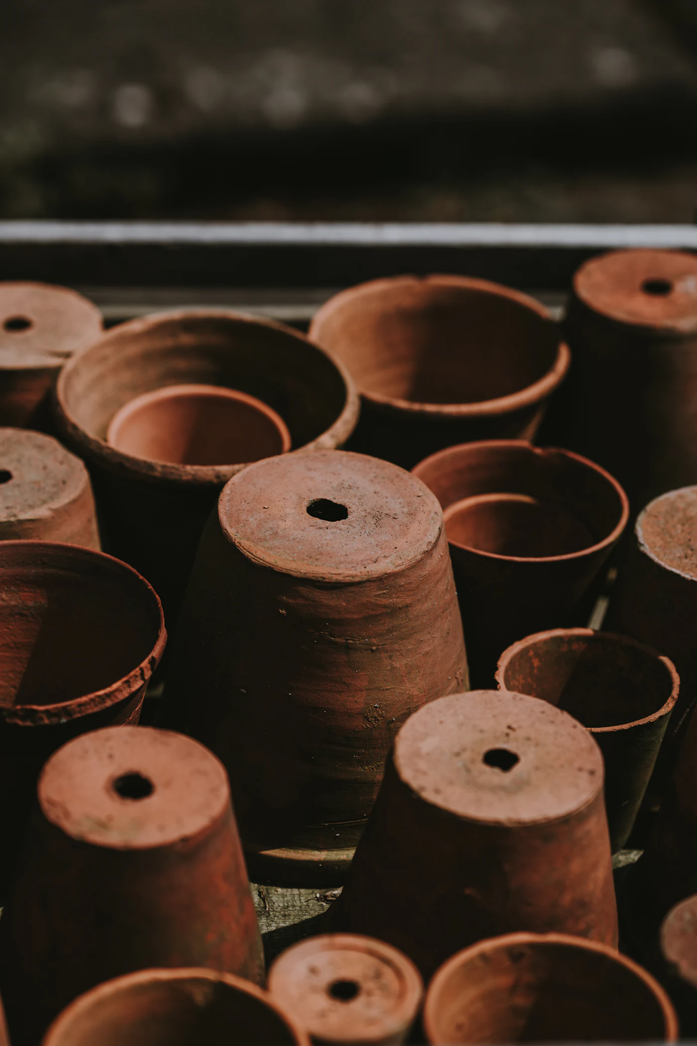 Terracotta flower pots, some standing and some turned upside down
