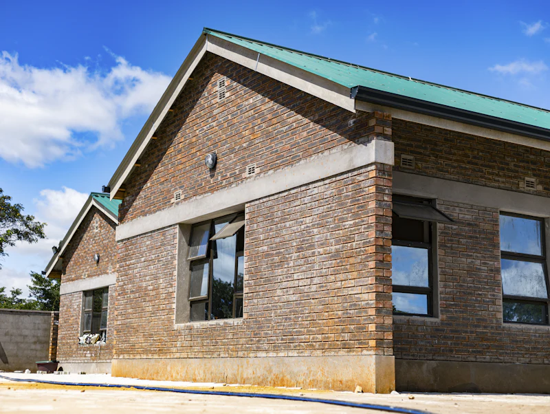 Brick building with a green metal roof