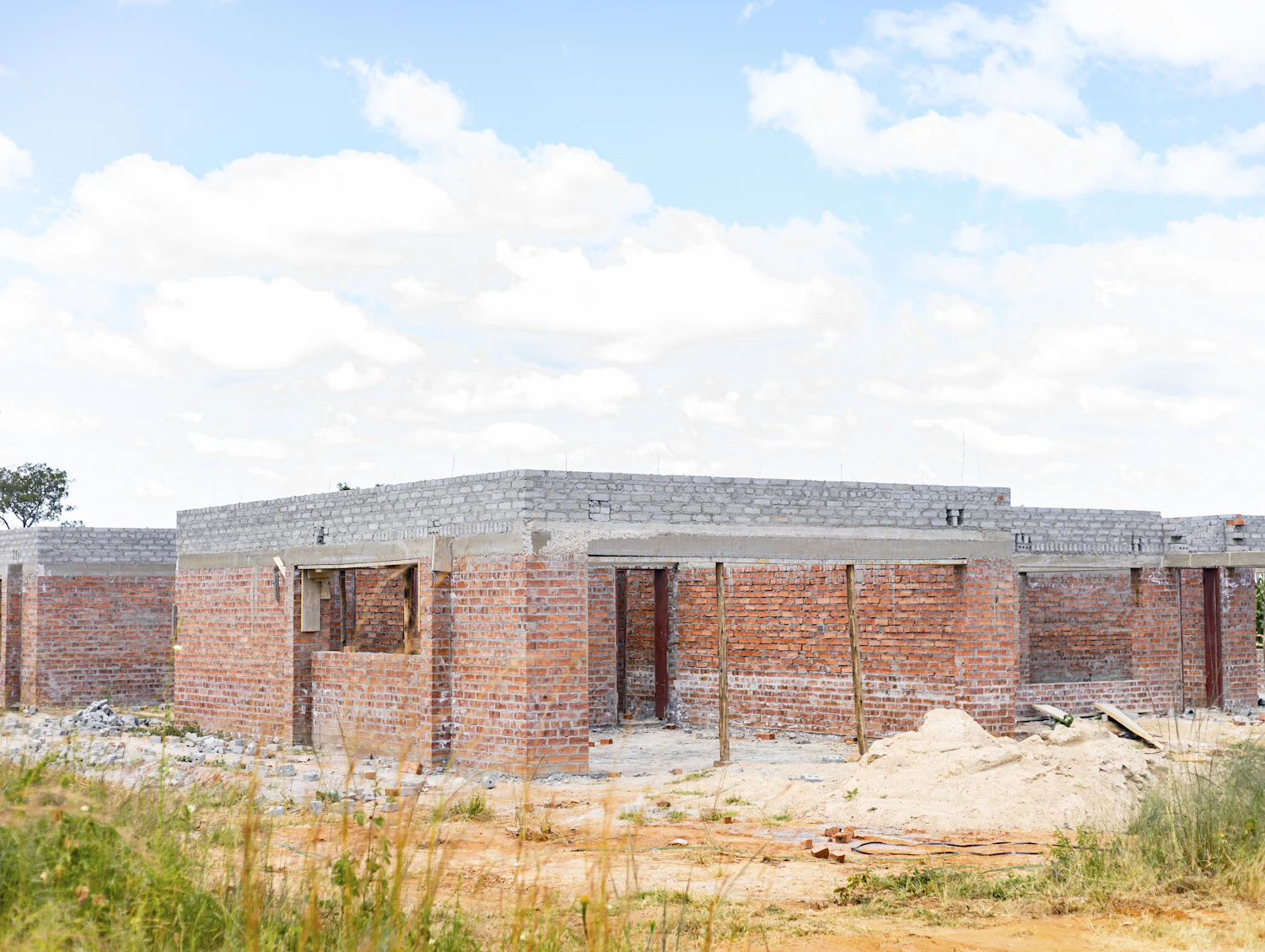Brick walls of a single-storey house going up on a building site